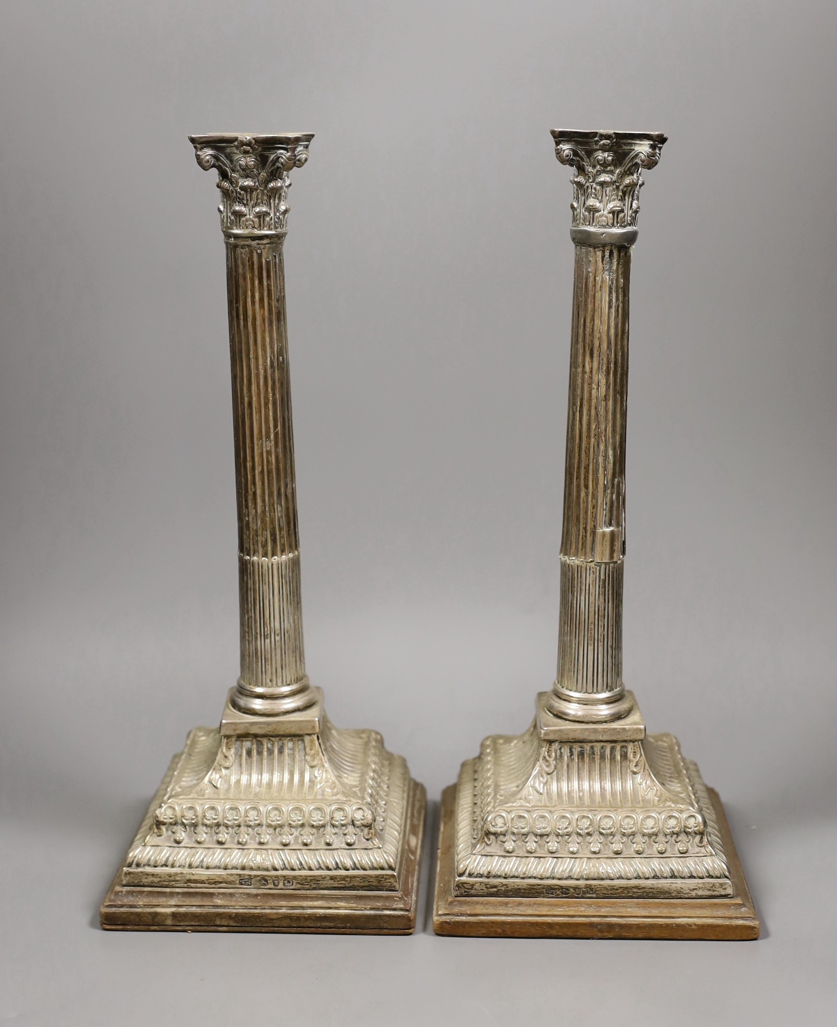 A pair of George II silver corinthian column candlesticks converted to table lamps, London 1759, height 33cm (a.f.)